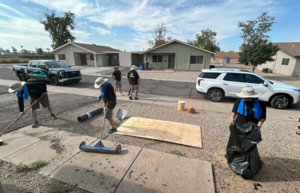 House of Refuge team cleaning up roofing materials and debris from roof replacement.